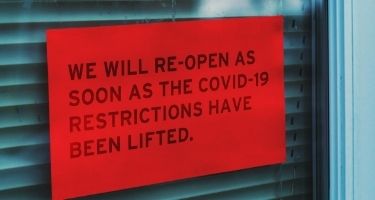 Sign in business window saying closed due to covid-19