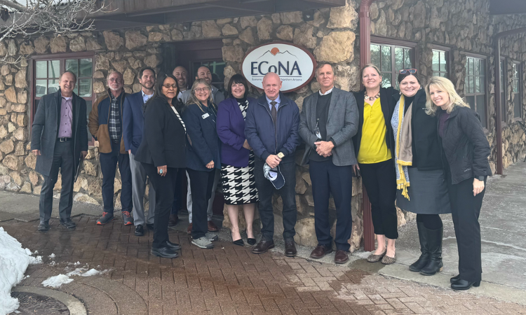 Senator Kelly posing with ECoNA board in front of the ECoNA offices.